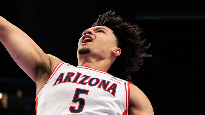 Mar 12, 2026; Kansas City, MO, USA; Arizona Wildcats guard Brayden Burries (5) shoots the ball over UCF Knights forward Jordan Burks (99) during the first half at T-Mobile Center. Mandatory Credit: William Purnell-Imagn Images