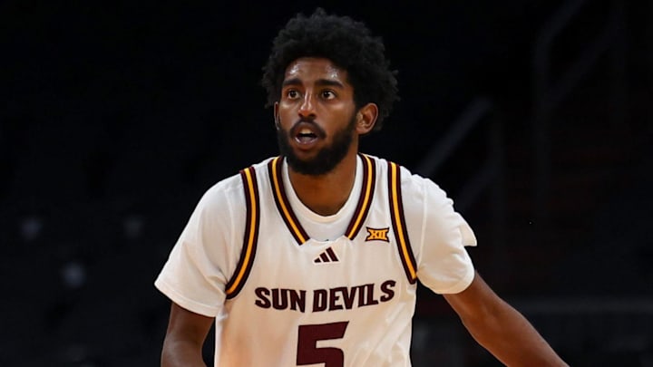 Dec 6, 2025; Phoenix, Arizona, USA; Arizona State University Sun Devils guard Moe Odum (5) dribbles down court against Oklahoma University Sooners forward Tae Davis (13) in the second half at PHX Arena. Mandatory Credit: Anna Carrington-Imagn Images