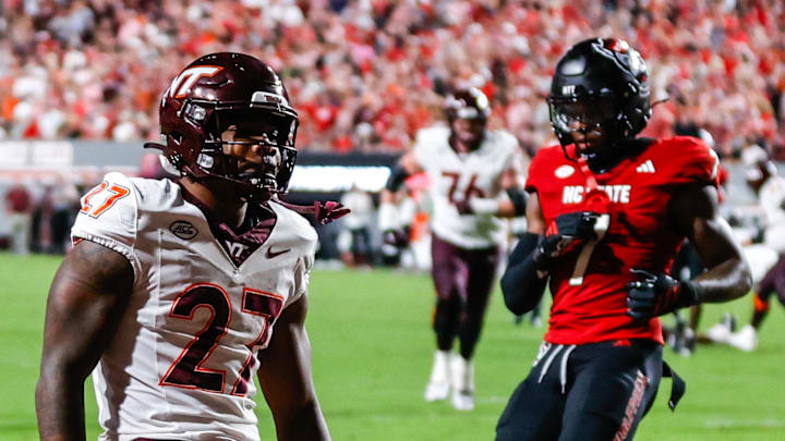 Sep 27, 2025; Raleigh, North Carolina, USA;  Virginia Tech Hokies running back Marcellous Hawkins (27) makes a touchdown and celebrates during the first half of the game against North Carolina State Wolfpack at Carter-Finley Stadium. Mandatory Credit: Jaylynn Nash-Imagn Images