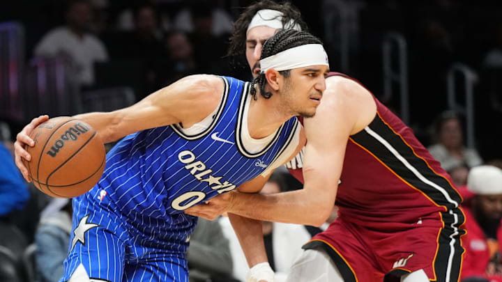Jan 28, 2026; Miami, Florida, USA;  Orlando Magic guard Anthony Black (0) drives past Miami Heat forward Jaime Jaquez Jr. (11) during the second half at Kaseya Center. Mandatory Credit: Jim Rassol-Imagn Images