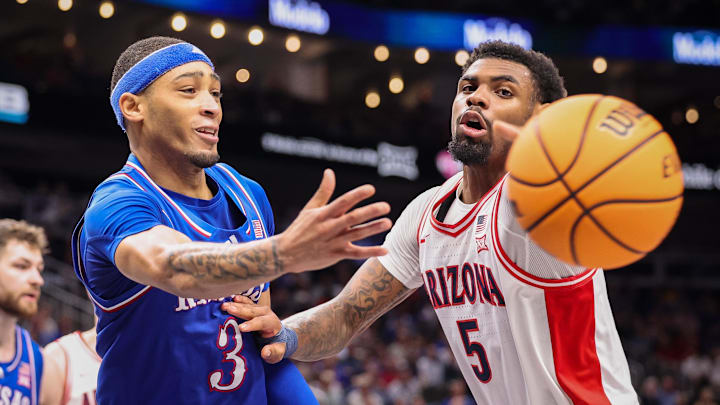 Kansas Jayhawks guard Dajuan Harris Jr. (3) passes the ball around Arizona Wildcats guard KJ Lewis (5) during the second half at T-Mobile Center.