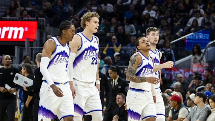 Jan 3, 2026; San Francisco, California, USA;  Utah Jazz forward Cody Williams (5) and forward Lauri Markkanen (23) and guard Keyonte George (3) and center Walker Kessler (24) walk off the court during a time out in the second quarter against the Golden State Warriors at Chase Center. Mandatory Credit: John Hefti-Imagn Images