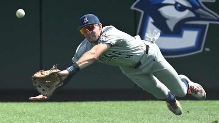 Jun 15, 2025; Omaha, Neb, USA; Arizona Wildcats right fielder Brendan Summerhill (4) tries to dive for a catch against the Arizona Wildcats during the eighth inning at Charles Schwab Field. Mandatory Credit: Steven Branscombe-Imagn Images Jun 15, 2025; Omaha, Neb, USA; Arizona Wildcats right fielder Brendan Summerhill (4) tries to dive for a catch against the Arizona Wildcats during the eighth inning at Charles Schwab Field. Mandatory Credit: Steven Branscombe-Imagn Images