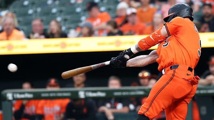 Apr 19, 2025; Baltimore, Maryland, USA; Baltimore Orioles outfielder Tyler O'Neill (9) hits a single during the eighth inning against the Cincinnati Reds at Oriole Park at Camden Yards.