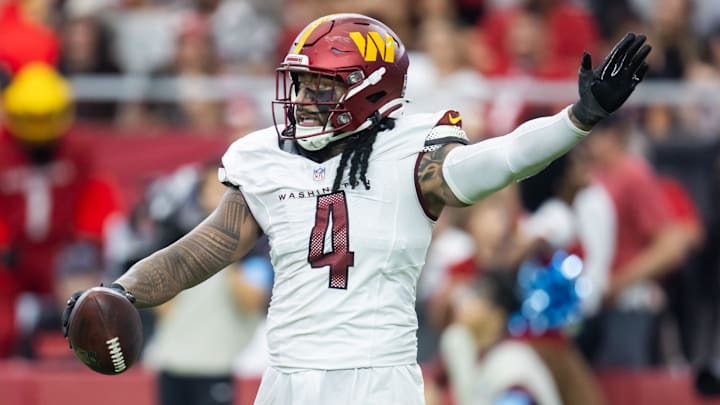 Sep 29, 2024; Glendale, Arizona, USA; Washington Commanders linebacker Frankie Luvu (4) celebrates a fumble recovery against the Arizona Cardinals in the second half at State Farm Stadium. Mandatory Credit: Mark J. Rebilas-Imagn Images