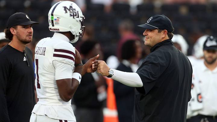 Mississippi State Bulldogs head coach Jeff Lebby (right) reacts with quarterback Kamario Taylor (1) during warm ups prior to the game against the Missouri Tigers at Davis Wade Stadium at Scott Field. Mississippi State Bulldogs head coach Jeff Lebby (right) reacts with quarterback Kamario Taylor (1) during warm ups prior to the game against the Missouri Tigers at Davis Wade Stadium at Scott Field.