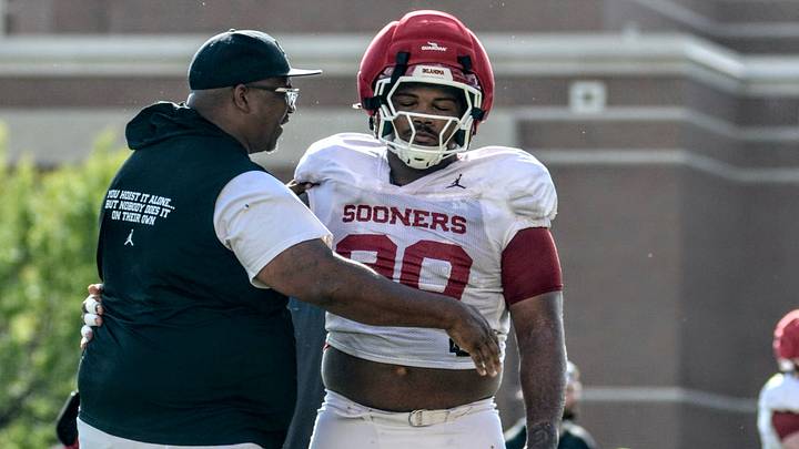 Oklahoma defensive tackles coach Todd Bates embraces defensive tackle Trent Wilson at practice. Oklahoma defensive tackles coach Todd Bates embraces defensive tackle Trent Wilson at practice.