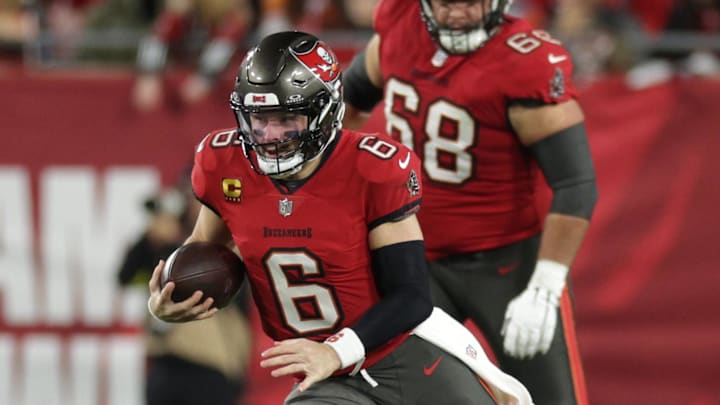 Baker Mayfield runs during a NFC wild card playoff against the Washington Commanders.