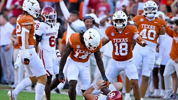 Oct 11, 2025; Dallas, Texas, USA; Texas Longhorns defensive end Brad Spence (14) stands over Oklahoma Sooners quarterback John Mateer (10) during the second half at the Cotton Bowl. Mandatory Credit: Jerome Miron-Imagn Images