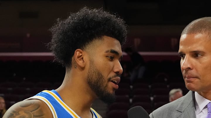 Mar 7, 2026; Los Angeles, California, USA; FS1 analyst Miles Simon (right) interviews UCLA Bruins guard Donovan Dent (2) after the game against the Southern California Trojans at the Galen Center. Mandatory Credit: Kirby Lee-Imagn Images