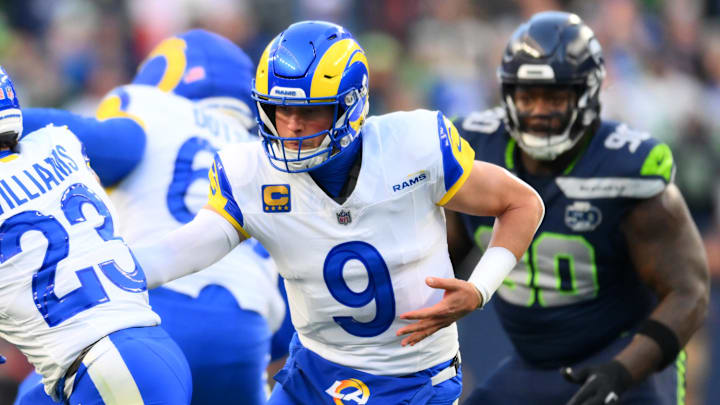 Los Angeles Rams quarterback Matthew Stafford (9) hands the ball off to running back Kyren Williams (23) 
