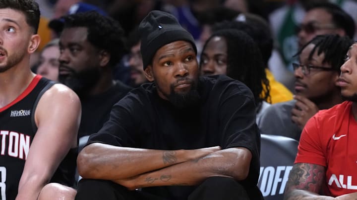 Apr 18, 2026; Los Angeles, California, USA; Houston Rockets center Alperen Sengun (28) and forward Kevin Durant (center) watch during the first half against the Los Angeles Lakers during game one of the first round of the 2026 NBA Playoffs at Crypto.com Arena. Mandatory Credit: Kirby Lee-Imagn Images