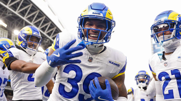 Nov 3, 2024; Seattle, Washington, USA; Los Angeles Rams safety Jaylen McCollough (39) celebrates with teammates, including cornerback Ahkello Witherspoon (4) and cornerback Charles Woods (21) following a first quarter interception against the Seattle Seahawks at Lumen Field. Mandatory Credit: Joe Nicholson-Imagn Images