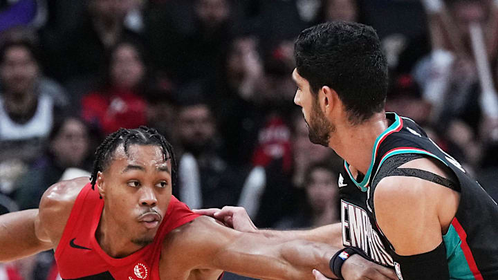Toronto Raptors forward Scottie Barnes controls the ball as Memphis Grizzlies forward Santi Aldama tries to defend.