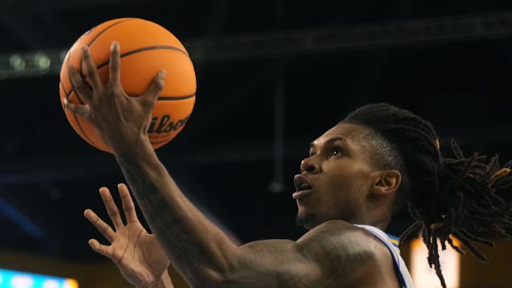 Dec 17, 2024; Los Angeles, California, USA; UCLA Bruins guard Dylan Andrews (2) shoots the ball against Prairie View A&M Panthers guard Jordan Tillmon (1) in the second half at Pauley Pavilion presented by Wescom. Mandatory Credit: Kirby Lee-Imagn Images