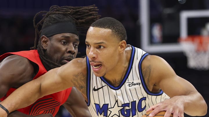 Orlando Magic guard Desmond Bane drives the ball past Portland Trail Blazers guard Jrue Holiday. Orlando Magic guard Desmond Bane drives the ball past Portland Trail Blazers guard Jrue Holiday.