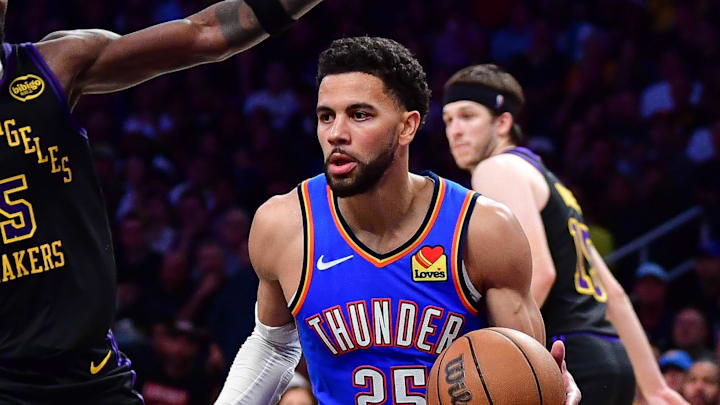 May 11, 2026; Los Angeles, California, USA; Oklahoma City Thunder guard Ajay Mitchell (25) moves the ball against Los Angeles Lakers center Deandre Ayton (5) during the second half in game four of the second round of the 2026 NBA Playoffs at Crypto.com Arena. Mandatory Credit: Gary A. Vasquez-Imagn Images