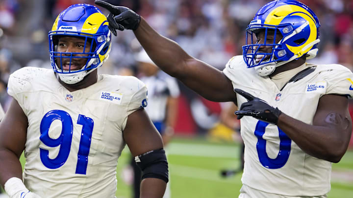 Los Angeles Rams defensive tackle Kobie Turner (91) with linebacker Byron Young (0). Mandatory Credit: Mark J. Rebilas-Imagn Images