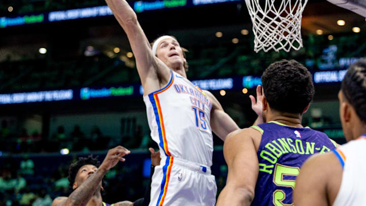 Apr 13, 2025; New Orleans, Louisiana, USA;  Oklahoma City Thunder center Branden Carlson (15) grabs a rebound against New Orleans Pelicans guard Elfrid Payton (4) during the first half at Smoothie King Center. Mandatory Credit: Stephen Lew-Imagn Images