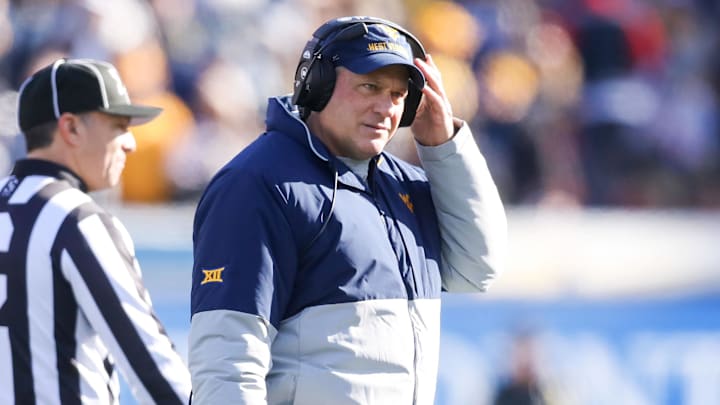 Nov 29, 2025; Morgantown, West Virginia, USA; West Virginia Mountaineers head coach Rich Rodriguez walks off the field after questioning a call with a referee during the first quarter against the Texas Tech Red Raiders at Milan Puskar Stadium. Mandatory Credit: Ben Queen-Imagn Images