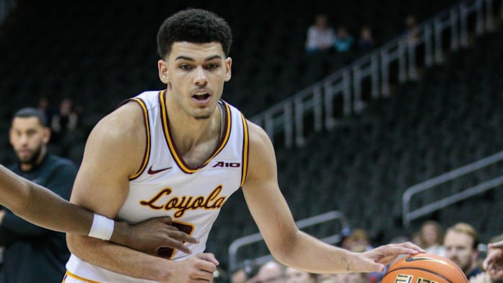Loyola Chicago guard Jayden Dawson dribbles the ball.