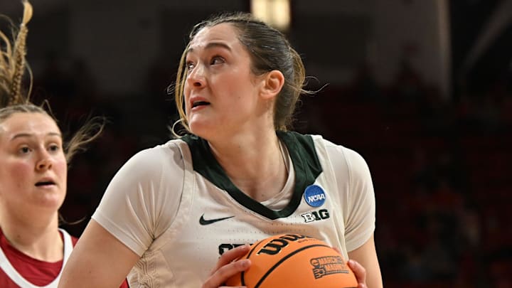 Mar 22, 2025; Raleigh, North Carolina, USA; Michigan State Spartans forward Grace VanSlooten (14) shoots against Harvard Crimson forward Abigail Wright (40) during the first half at James T. Valvano Arena at William Neal Reynolds. Mandatory Credit: William Howard-Imagn Images