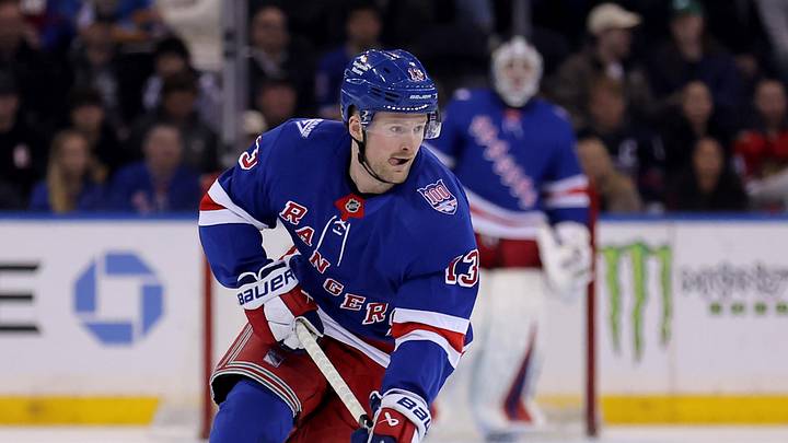 Mar 27, 2026; New York, New York, USA; New York Rangers left wing Alexis Lafreniere (13) brings the puck up ice against the Chicago Blackhawks during the second period at Madison Square Garden.