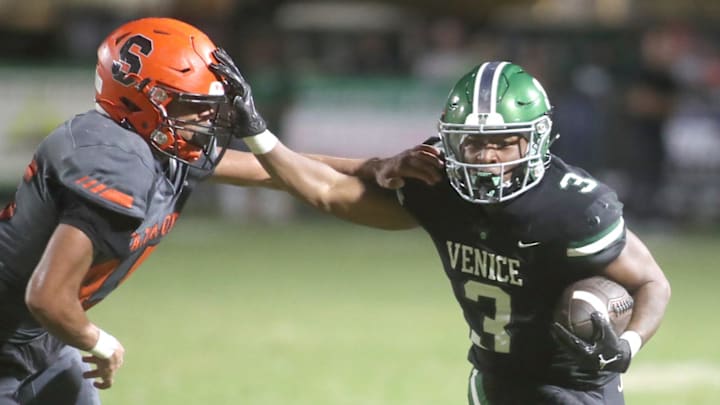 Venice running back Jamarice Wilder gets an edge on Sarasota's Brian Klingel during a game last season.