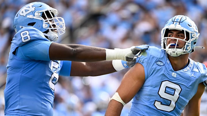 Sep 13, 2025; Chapel Hill, North Carolina, USA; North Carolina Tar Heels defensive lineman Melkart Abou-Jaoude (9 ) celebrates with defensive lineman Smith Vilbert (8) after making a sack in the first quarter at Kenan Stadium. Mandatory Credit: Bob Donnan-Imagn Images