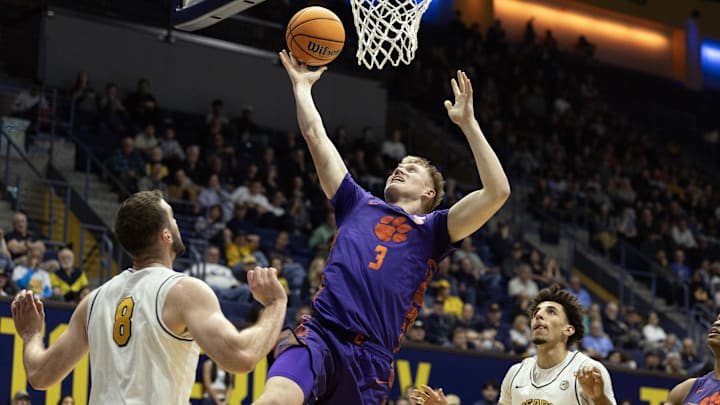 Feb 7, 2026; Berkeley, California, USA; Clemson Tigers forward Chase Thompson (3) lays the ball up between California Golden Bears defenders Milos Ilić (8) and Justin Pippen (10) during the first half at Haas Pavilion. Mandatory Credit: D. Ross Cameron-Imagn Images