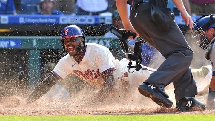 Philadelphia Phillies center fielder Roman Quinn slides safely into home with the winning run