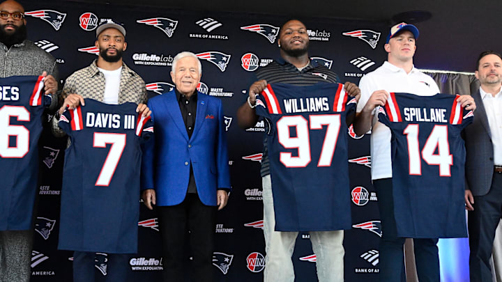 Mar 13, 2025; Foxborough, MA, USA; The New England Patriots hold a press conference at the GP Atrium at Gillette Stadium to introduce free agency additions to the team. (Left to right) New England Patriots head coach Mike Vrabel, offensive tackle Morgan Moses, cornerback Carlton Davis III, owner Robert Kraft, defensive tackle Milton Williams, linebacker Robert Spillane and executive vice president of player personnel Eliot Wolf. Mandatory Credit: Eric Canha-Imagn Images