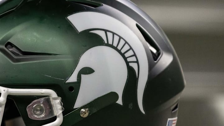Nov 24, 2023; Detroit, Michigan, USA; A Michigan State Spartans helmet sits on a bench during the second half game against the Penn State Nittany Lions at Ford Field. Mandatory Credit: David Reginek-Imagn Images Nov 24, 2023; Detroit, Michigan, USA; A Michigan State Spartans helmet sits on a bench during the second half game against the Penn State Nittany Lions at Ford Field. Mandatory Credit: David Reginek-Imagn Images