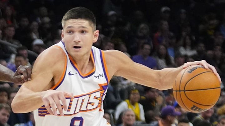 Suns guard Grayson Allen (8) drives to the lane against Warriors forward Draymond Green (23) during a game at Mortgage Matchup Center in Phoenix on Feb. 5, 2026. Suns guard Grayson Allen (8) drives to the lane against Warriors forward Draymond Green (23) during a game at Mortgage Matchup Center in Phoenix on Feb. 5, 2026.