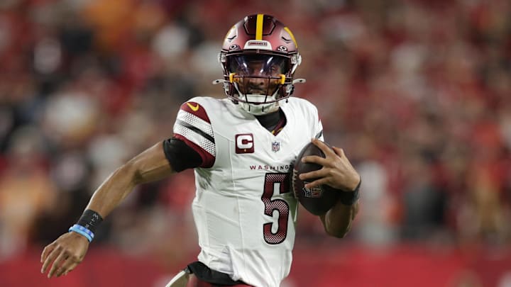 Jan 12, 2025; Tampa, Florida, USA; Washington Commanders quarterback Jayden Daniels (5) scrambles during the first quarter of a NFC wild card playoff against the Tampa Bay Buccaneers at Raymond James Stadium. Mandatory Credit: Nathan Ray Seebeck-Imagn Images