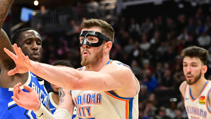 Mar 16, 2025; Milwaukee, Wisconsin, USA; Oklahoma City Thunder center Isaiah Hartenstein (55) passes the ball away from Milwaukee Bucks guard Taurean Prince (12) in the second quarter at Fiserv Forum. Mandatory Credit: Benny Sieu-Imagn Images