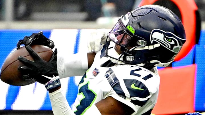 Seattle Seahawks cornerback Tariq Woolen intercepts a pass against the Rams.