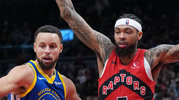 Golden State Warriors guard Stephen Curry passes the ball as Toronto Raptors forward Brandon Ingram tries to defend.