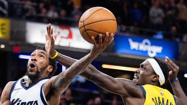 Sacramento Kings guard Malik Monk shoots the ball while Indiana Pacers forward Obi Toppin and forward Pascal Siakam defend