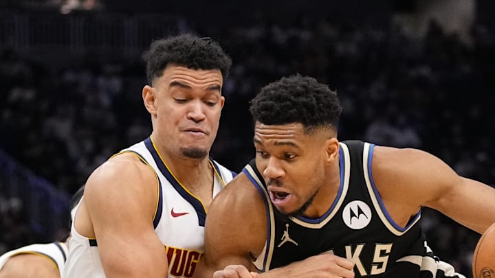 Milwaukee Bucks forward Giannis Antetokounmpo drives for the basket against Denver Nuggets forward Spencer Jones.
