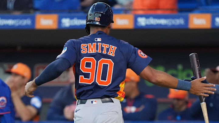 Mar 6, 2025; Port St. Lucie, Florida, USA;  Houston Astros infielder Cam Smith (90) celebrates scoring a run with teammate Chas McCormick, right, in the first inning against the New York Mets at Clover Park
