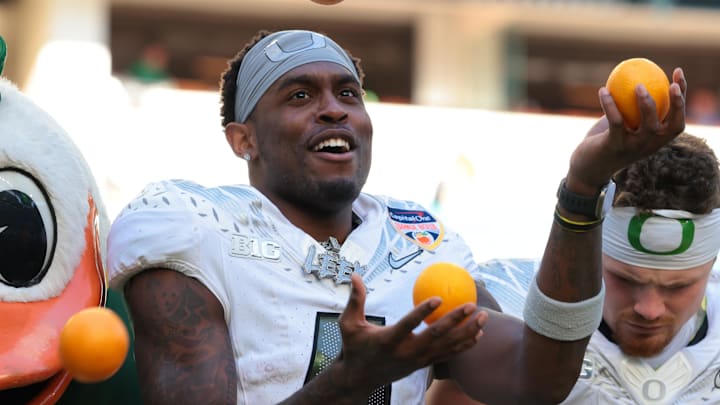 Jan 1, 2026; Miami Gardens, FL, USA; Oregon Ducks wide receiver Malik Benson (4) juggles oranges as the “The Duck” celebrates following the 2025 Orange Bowl and quarterfinal game of the College Football Playoff against the Texas Tech Red Raiders at Hard Rock Stadium. Mandatory Credit: Sam Navarro-Imagn Images
