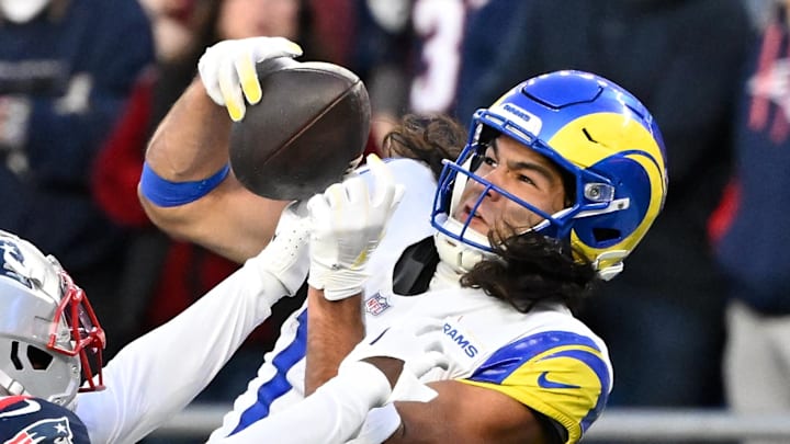 Nov 17, 2024; Foxborough, Massachusetts, USA;  New England Patriots cornerback Jonathan Jones (31) breaks up a pass to Los Angeles Rams wide receiver Puka Nacua (17) during the second half at Gillette Stadium. Mandatory Credit: Eric Canha-Imagn Images