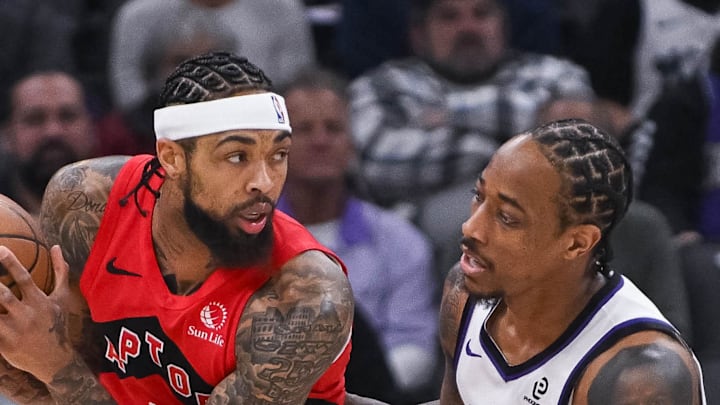 Toronto Raptors forward Brandon Ingram controls the ball against Sacramento Kings guard/forward DeMar DeRozan.