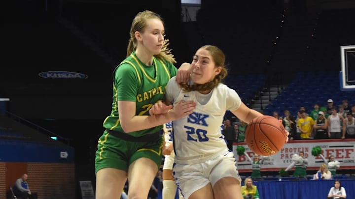 Simon Kenton guard Bella Ober tries to drive around an Owensboro Catholic defender in a Kentucky girls state quarterfinal game March 13, 2026. 