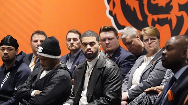 Jan 22, 2025; Lake Forest, IL, USA; Chicago Bears quarterback Caleb Williams to (C) listens as new head coach Ben Johnson (not pictured) answers questions during a introductory press conference at PNC Center. Mandatory Credit: David Banks-Imagn Images