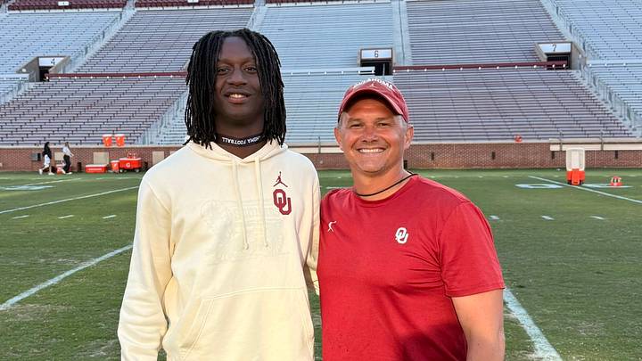 Oklahoma prospect Kamieon Compton-Nero poses with safeties coach Brandon Hall at an unofficial visit.