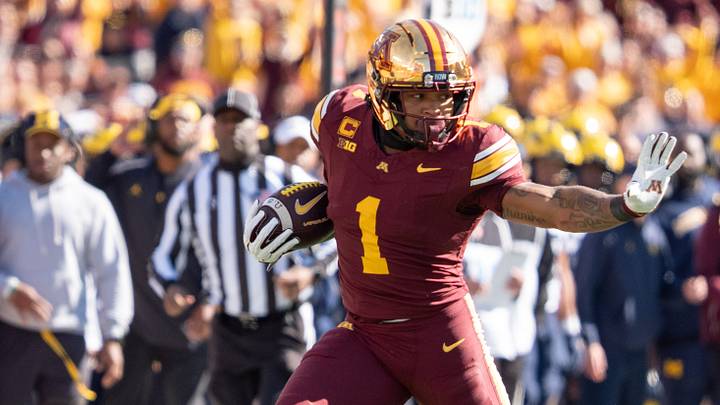 Oct 3, 2026; Minneapolis, Minnesota, USA; Minnesota Golden Gophers running back Darius Taylor (1) runs with the ball as Michigan Wolverines safety Rod Moore (1) and linebacker Nathaniel Staehling (44) defend in the first quarter at Huntington Bank Stadium. Mandatory Credit: Matt Blewett-Imagn Images Oct 3, 2026; Minneapolis, Minnesota, USA; Minnesota Golden Gophers running back Darius Taylor (1) runs with the ball as Michigan Wolverines safety Rod Moore (1) and linebacker Nathaniel Staehling (44) defend in the first quarter at Huntington Bank Stadium. Mandatory Credit: Matt Blewett-Imagn Images