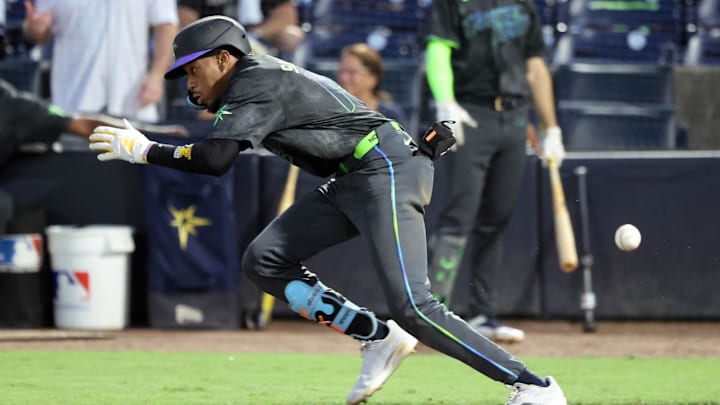 Tampa Bay Rays outfielder Chandler Simpson (14) hits a bunt single against the Baltimore Orioles during the fourth inning at George M. Steinbrenner Field. Tampa Bay Rays outfielder Chandler Simpson (14) hits a bunt single against the Baltimore Orioles during the fourth inning at George M. Steinbrenner Field.