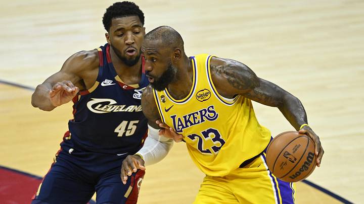 Jan 28, 2026; Cleveland, Ohio, USA; Cleveland Cavaliers guard Donovan Mitchell (45) defends Los Angeles Lakers forward LeBron James (23) in the fourth quarter at Rocket Arena. Mandatory Credit: David Richard-Imagn Images